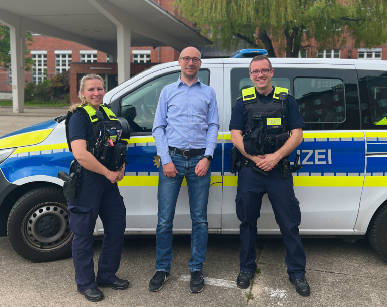 Ruppert Stüwe mit einer Polizistin und einem Polizisten